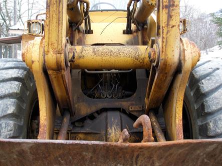 Close-up photo of front end of a loader has a somewhat menacing, insect-like appearance.   Bordered Page size 3000 x 2250px (300ppi).  Actual image size 10 x 7.5".