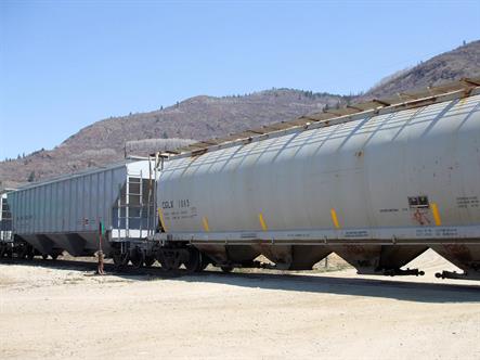 A couple of tank cars on a siding.  Bare, dry hills in the background, blue sky above.  Half-Page size 3000 x 2250px (300ppi).  Actual image size 10 x 7.5".